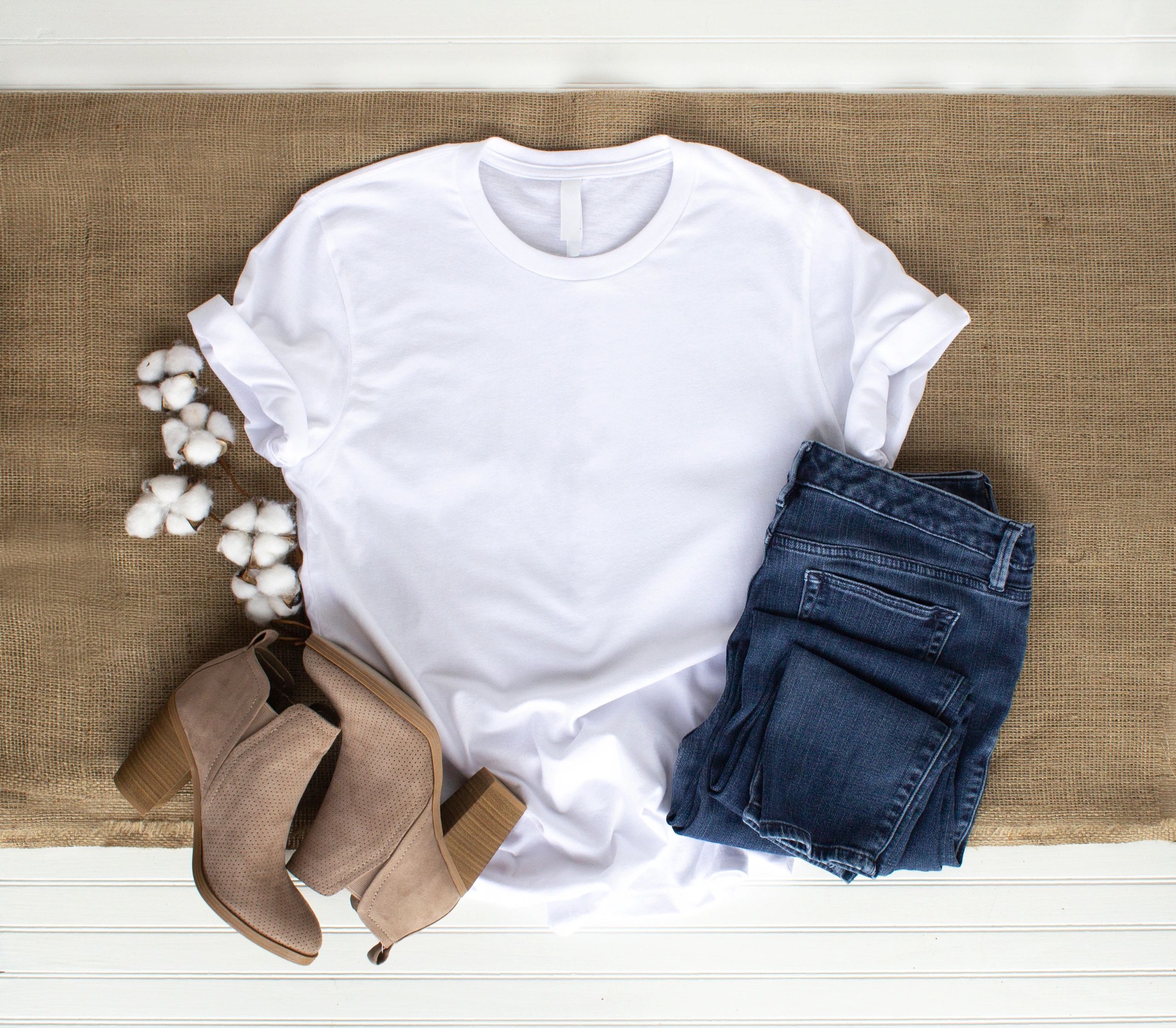 White t-shirt mockup flat lay with jeans and boots.