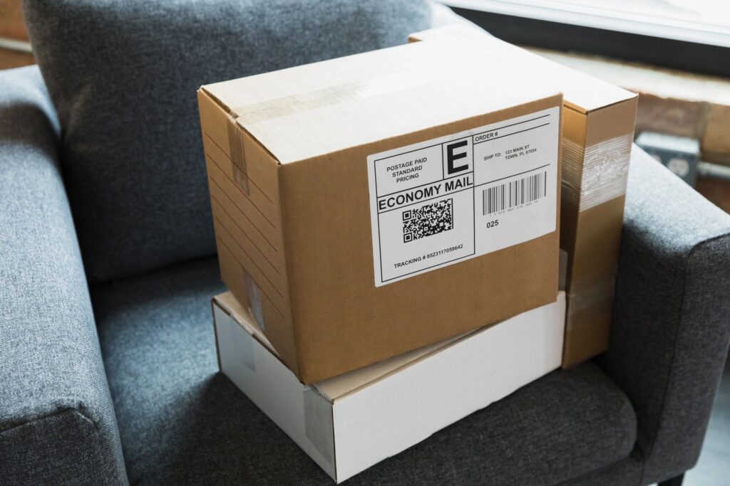 Two Cardboard Boxes Stacked on a Gray Chair