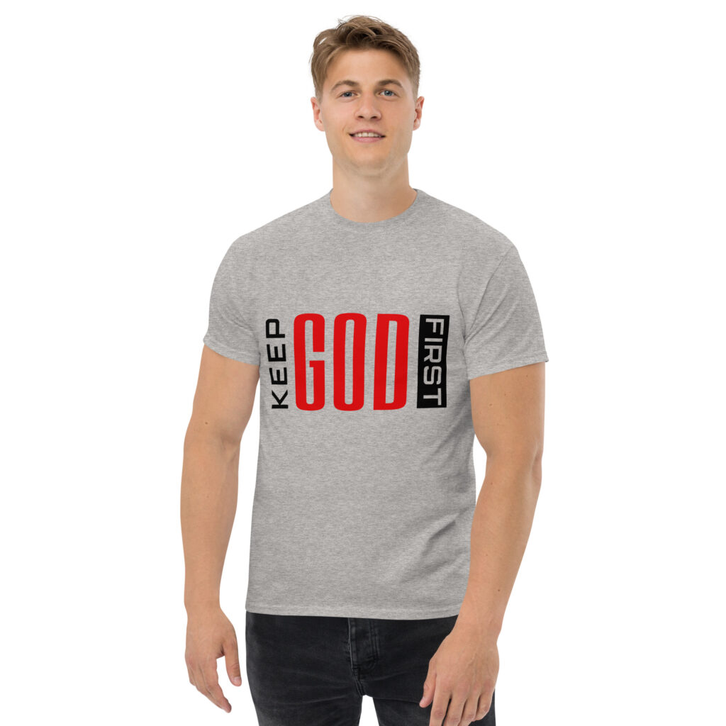 Man wearing a grey t-shirt with the text 'KEEP GOD FIRST'.
