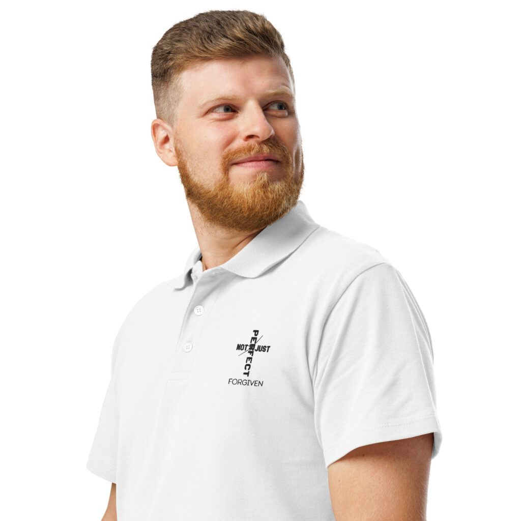 Smiling man wearing a white polo shirt with text design on the chest.
