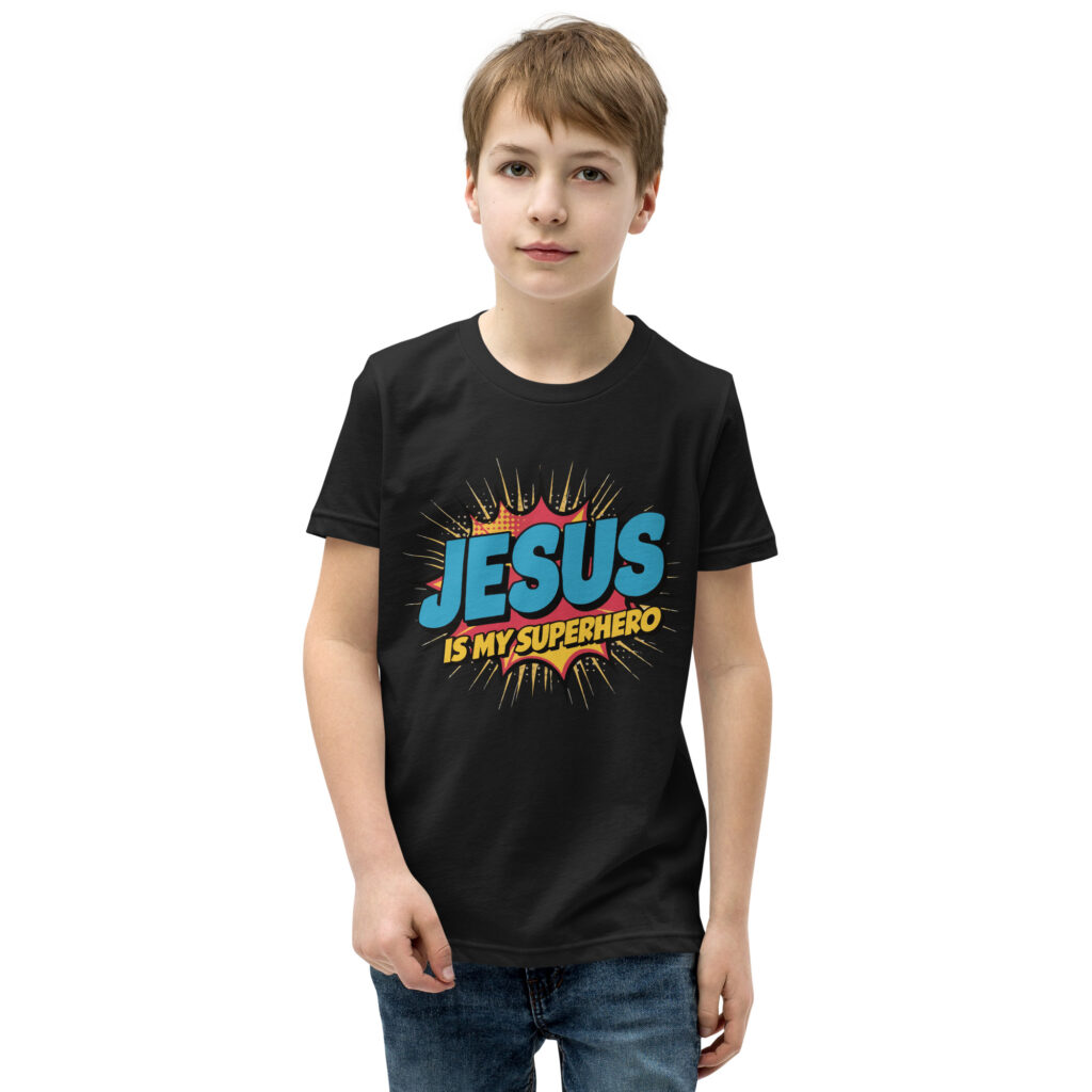 Young boy wearing a black t-shirt with colorful 'Jesus is my superhero' text.